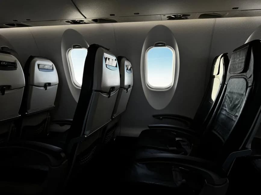 Japan Airlines Boeing 767-300 economy class cabin interior with rows of seats